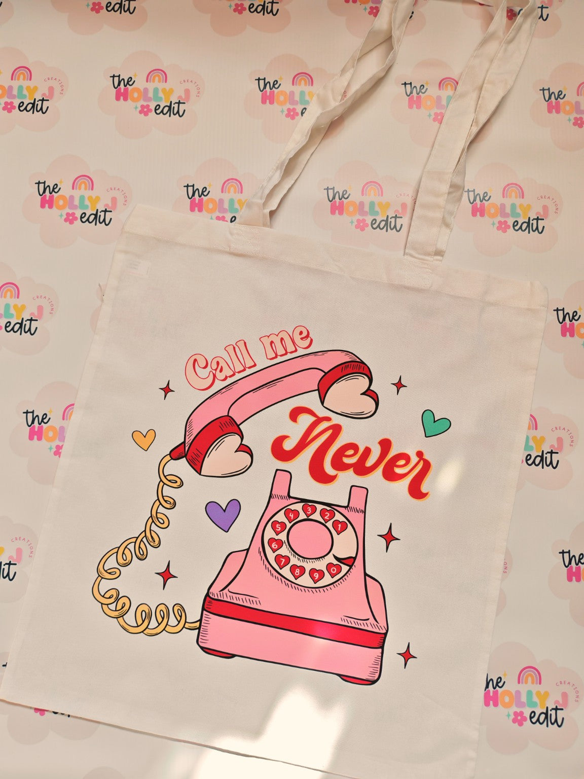 White cotton tote bag with retro pink telephone and Call Me Never design