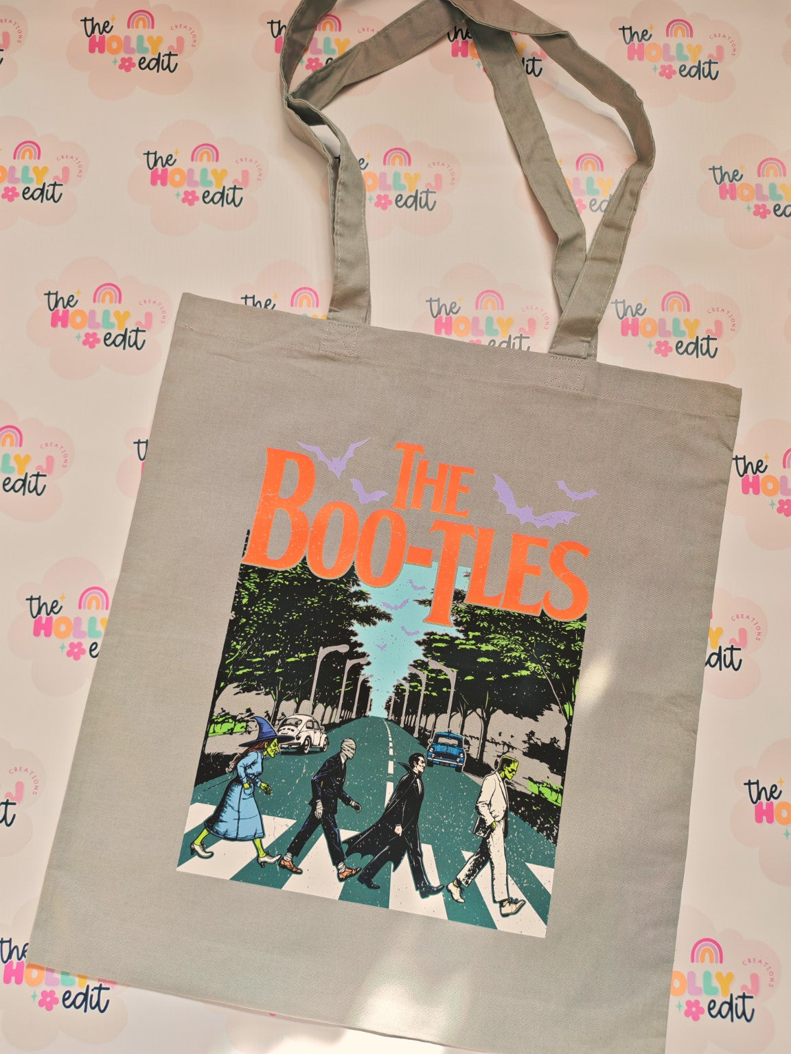 Grey cotton tote bag with retro horror themed road crossing design and The Bootles text