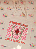 White cotton tote bag with skeleton hands forming a heart and pink checkerboard design