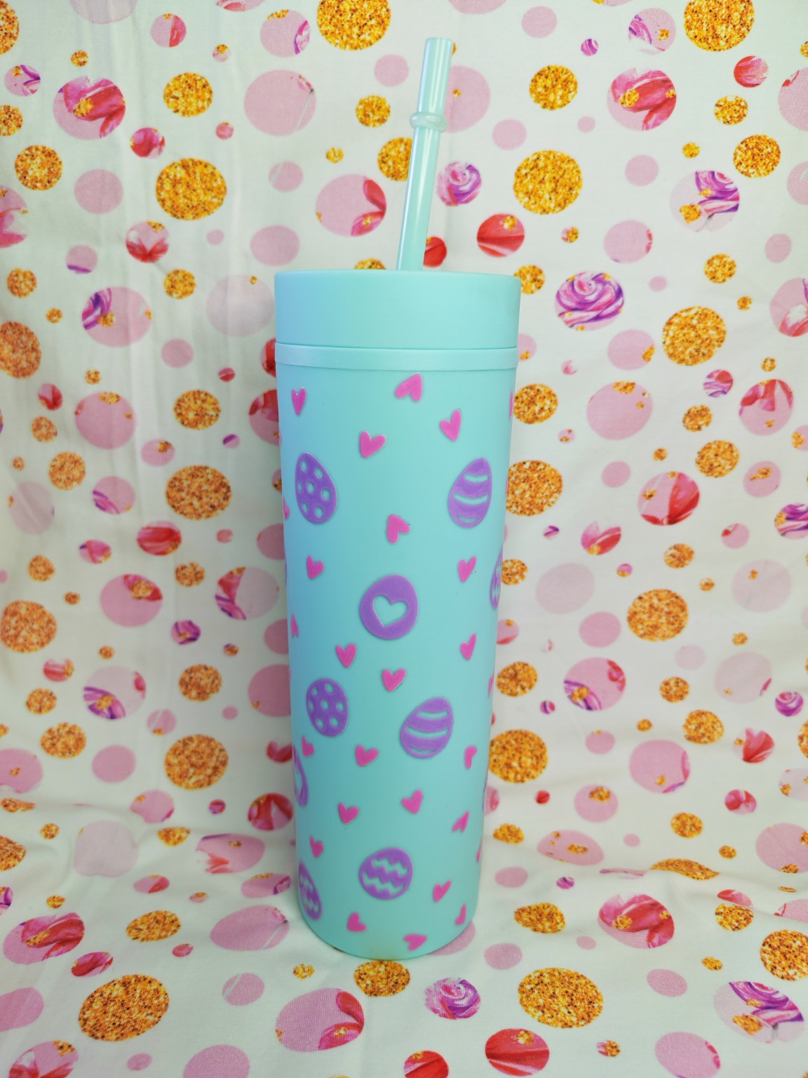 Light blue 16oz skinny tumbler with pastel Easter eggs and pink hearts