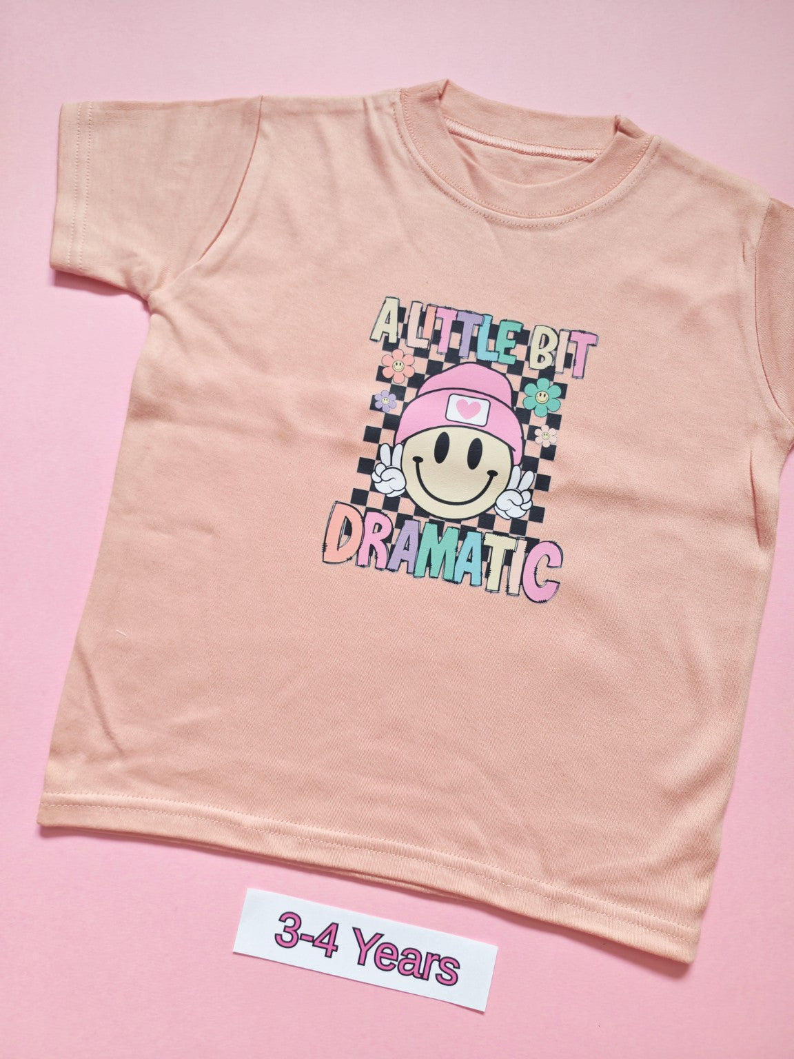 Pink children's T-shirt with colourful A Little Bit Dramatic smiley design, size 3-4 years