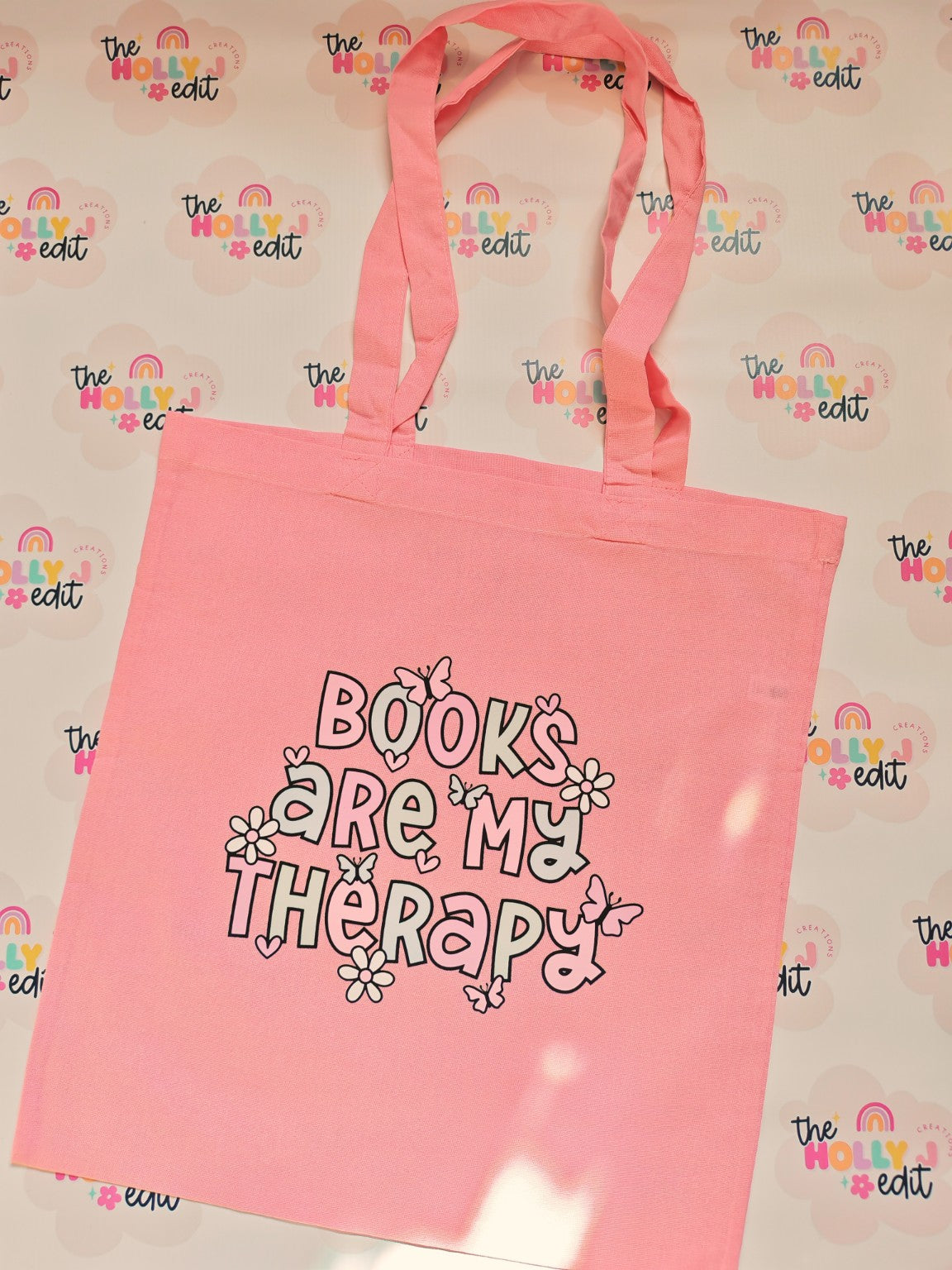 Pink tote bag with Books Are My Therapy design