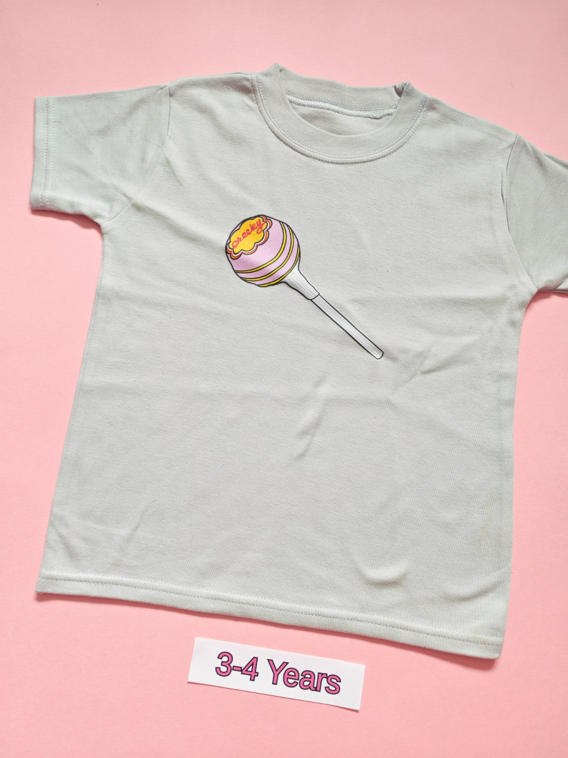 White children's T-shirt with pastel pink Cheeky lollipop design, size 3-4 years