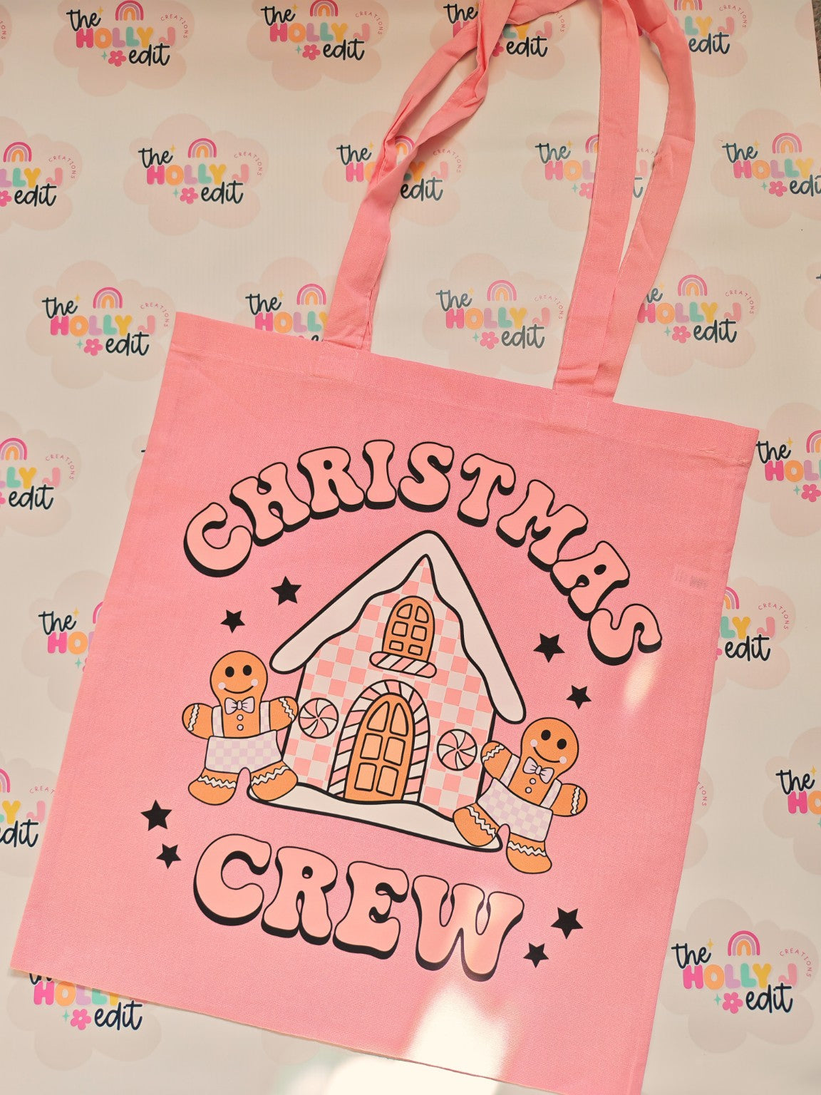 Pink cotton tote bag with Christmas Crew gingerbread house and gingerbread characters design