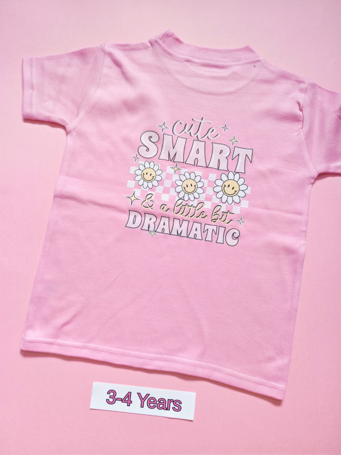 Pink children's T-shirt with Cute Smart and a Little Bit Dramatic daisy design, size 3-4 years, back