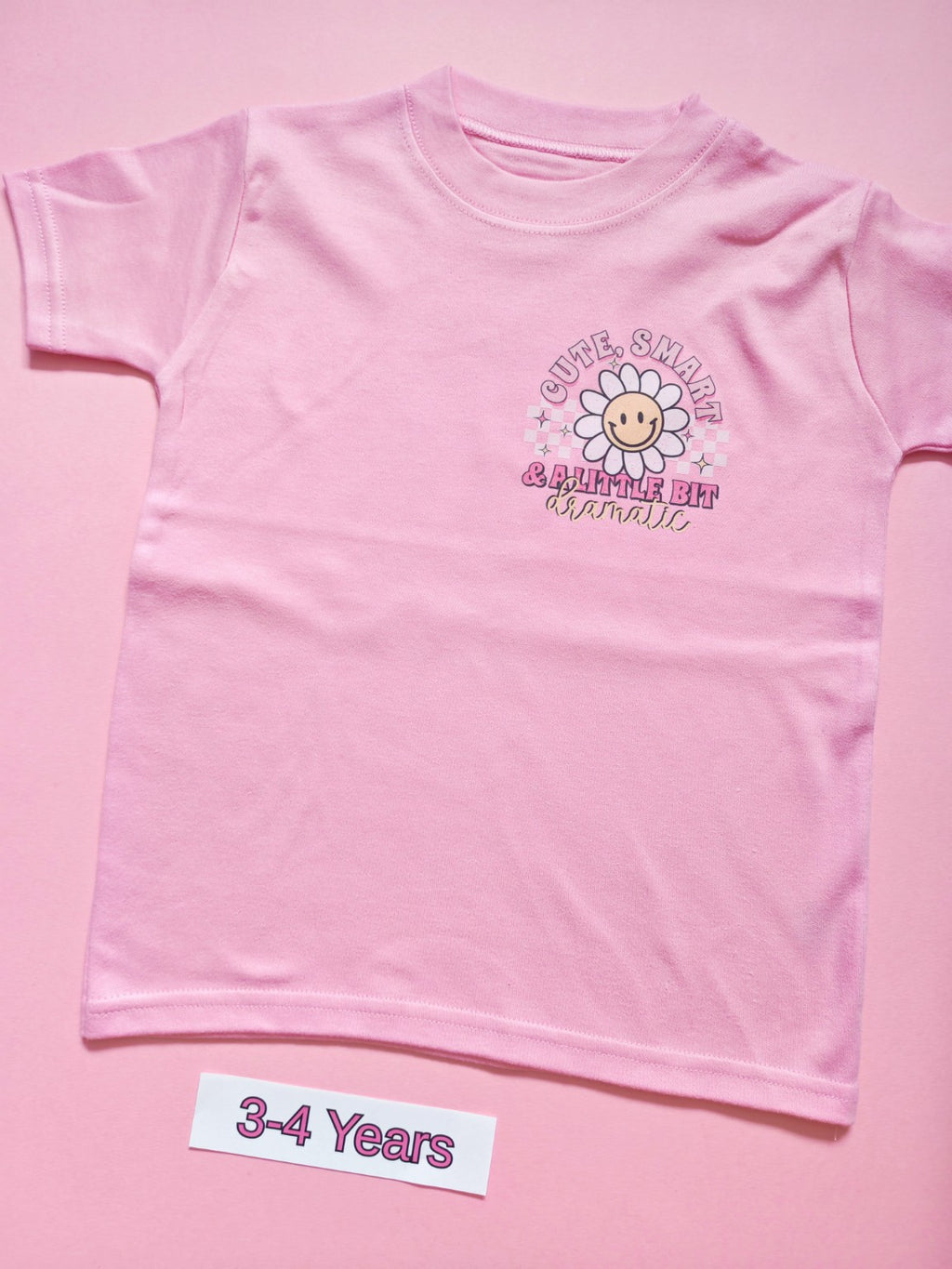 Pink children's T-shirt with Cute Smart and a Little Bit Dramatic daisy design, size 3-4 years, front
