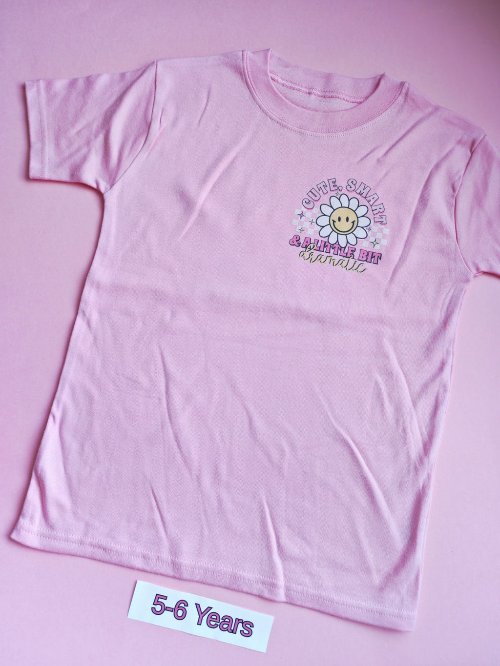Pink children's t-shirt with cute smart and a little bit dramatic daisy design, 5-6 years, front