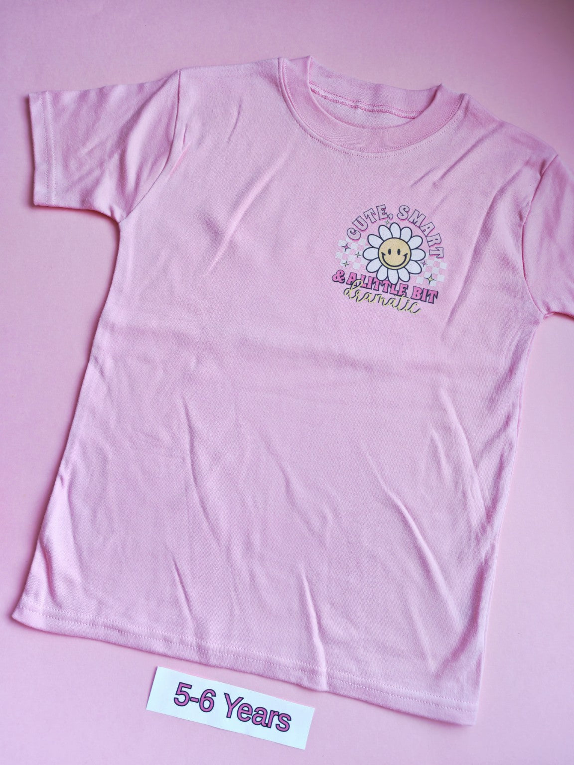 Pink children's t-shirt with cute smart and a little bit dramatic daisy design, 5-6 years, front