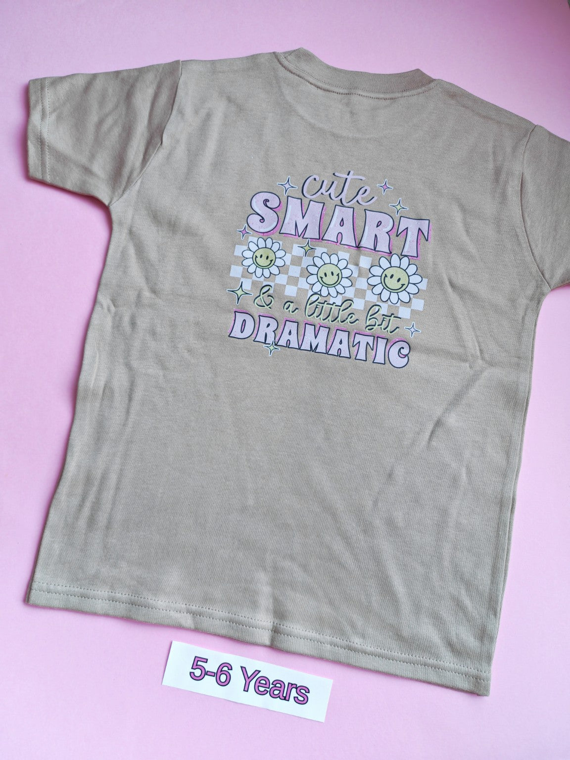Taupe children's t-shirt with Cute Smart and a Little Bit Dramatic daisy design on the back, 5-6 years