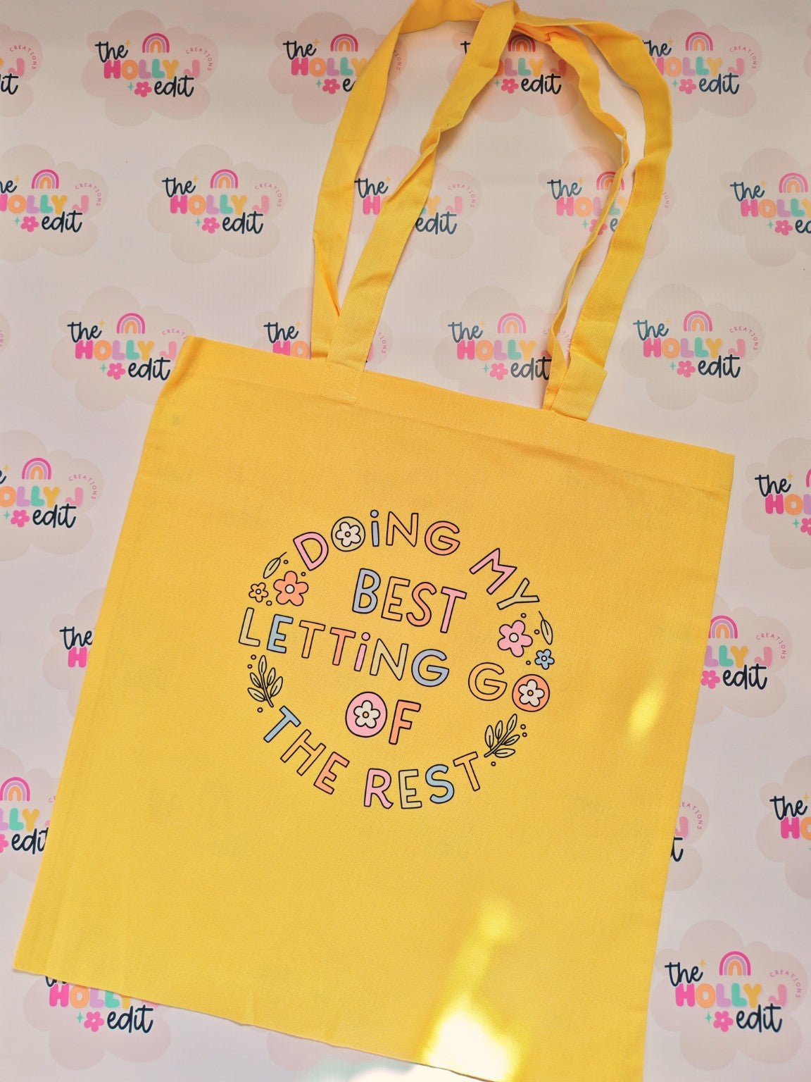 Yellow cotton tote bag with colourful floral Doing My Best Letting Go Of The Rest design