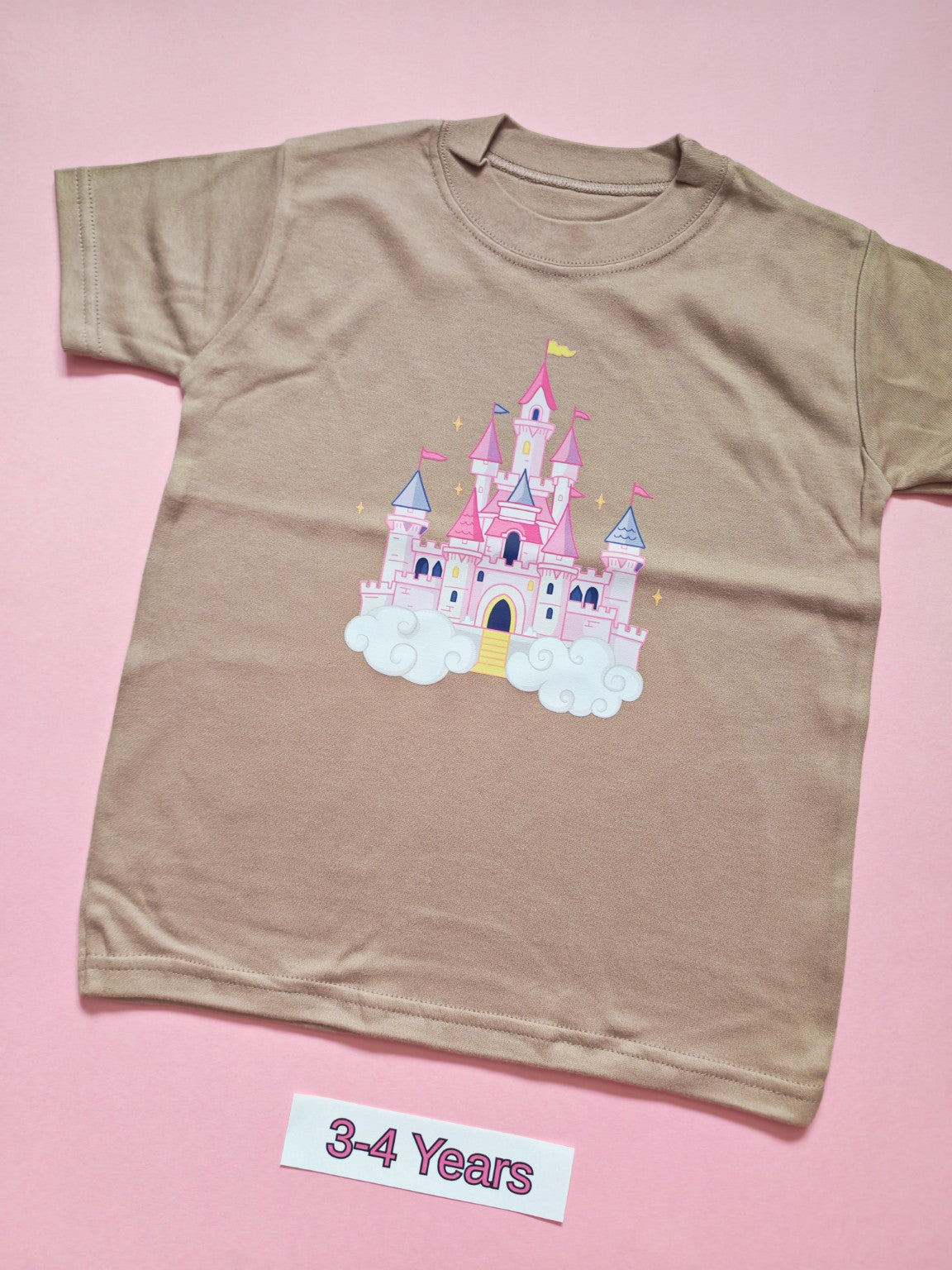Taupe children's T-shirt with pastel pink fairytale castle design, size 3-4 years