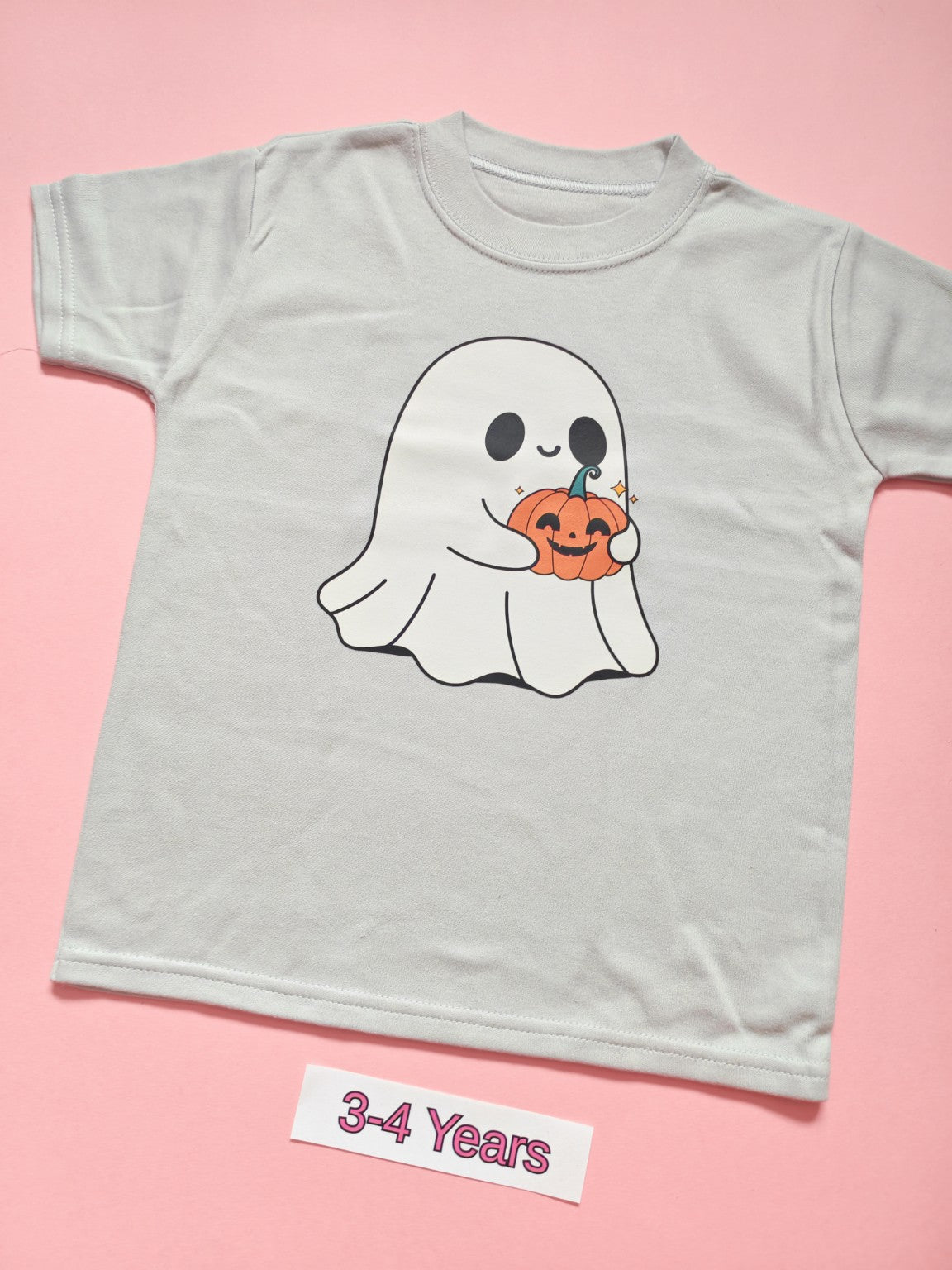 White children's T-shirt with cute ghost holding a pumpkin Halloween design, size 3-4 years