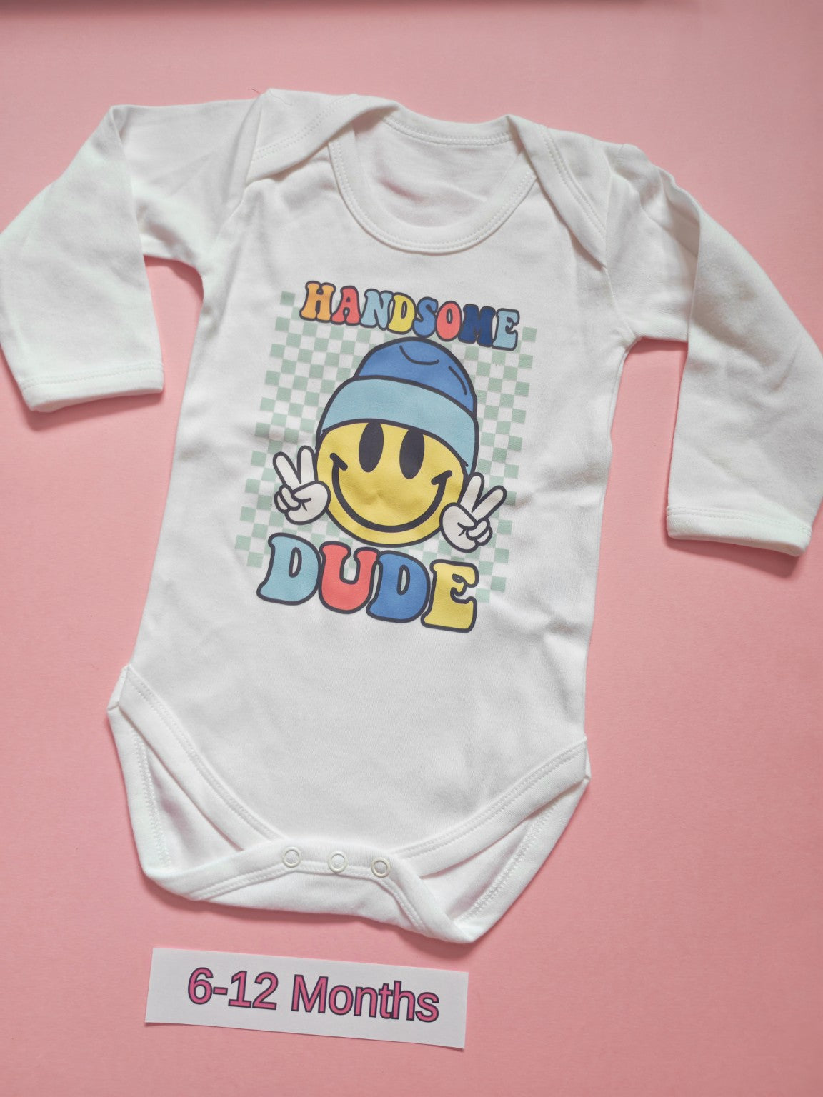 White long sleeve baby bodysuit with colourful Handsome Dude smiley design, size 6-12 months