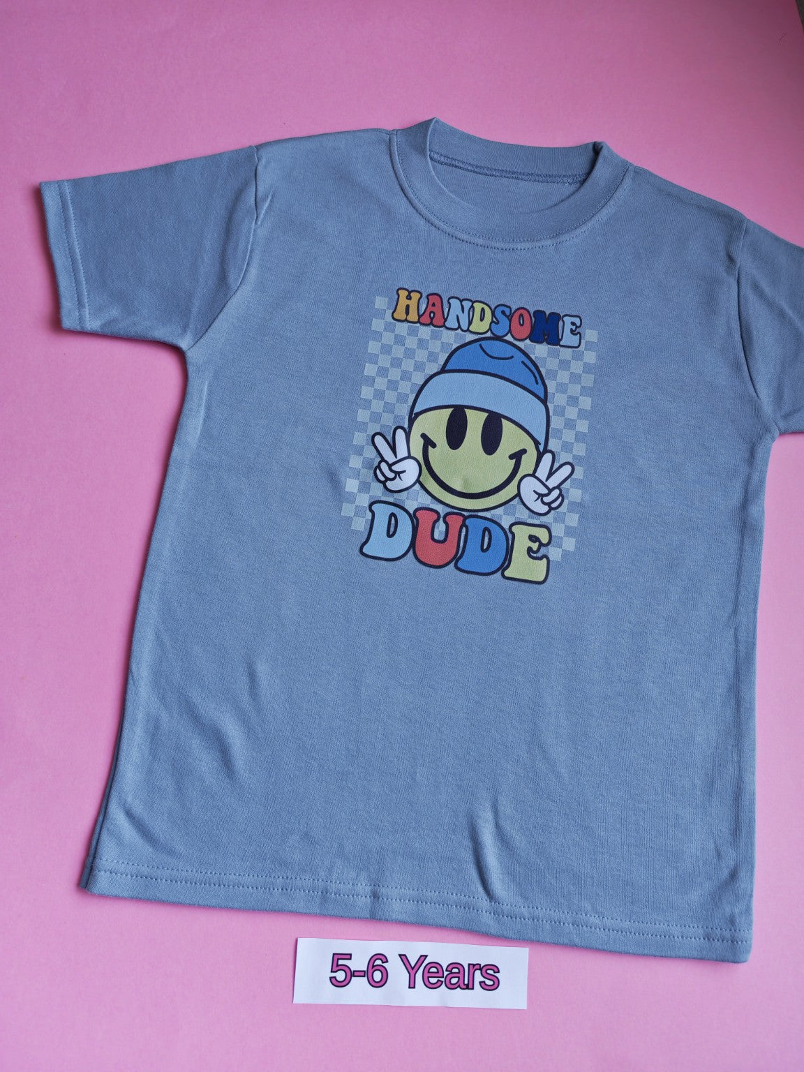 Blue children's t-shirt with Handsome Dude smiley face design, size 5-6 years