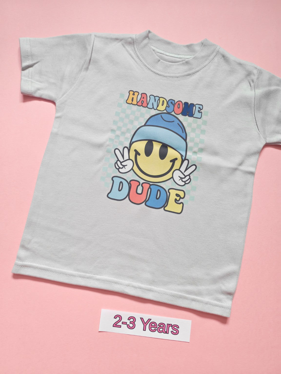 White children's T-shirt with colourful Handsome Dude smiley design, size 2-3 years