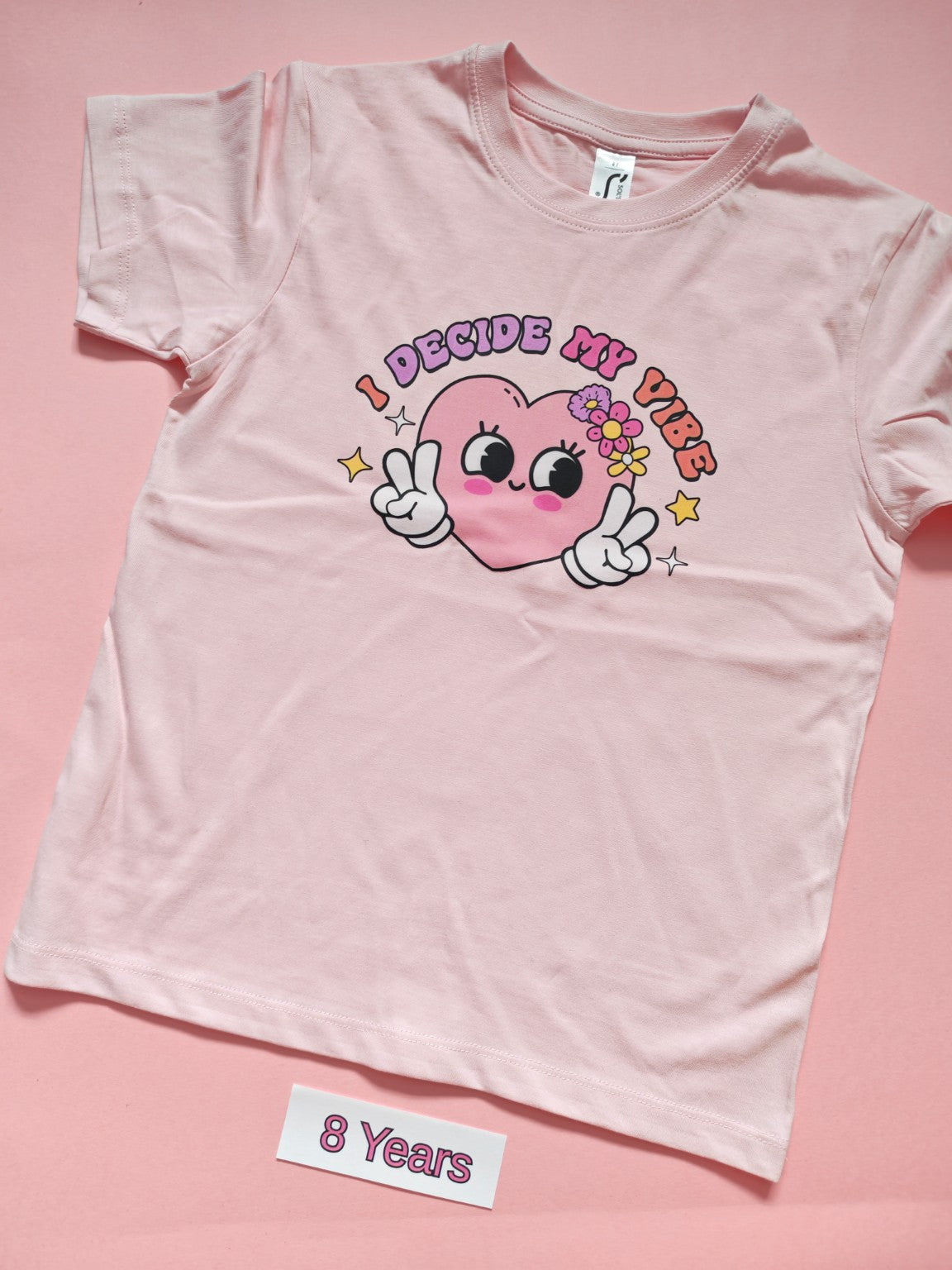 Pale pink children's T-shirt with I Decide My Vibe heart design, size 8 years