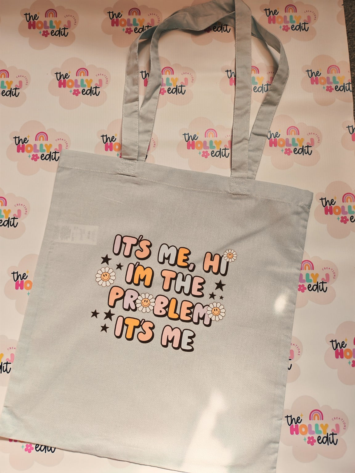 Grey cotton tote bag with Its Me Hi Im The Problem Its Me design and daisies