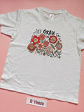 White children's T-shirt with It's Okay floral positive message design, size 8 years