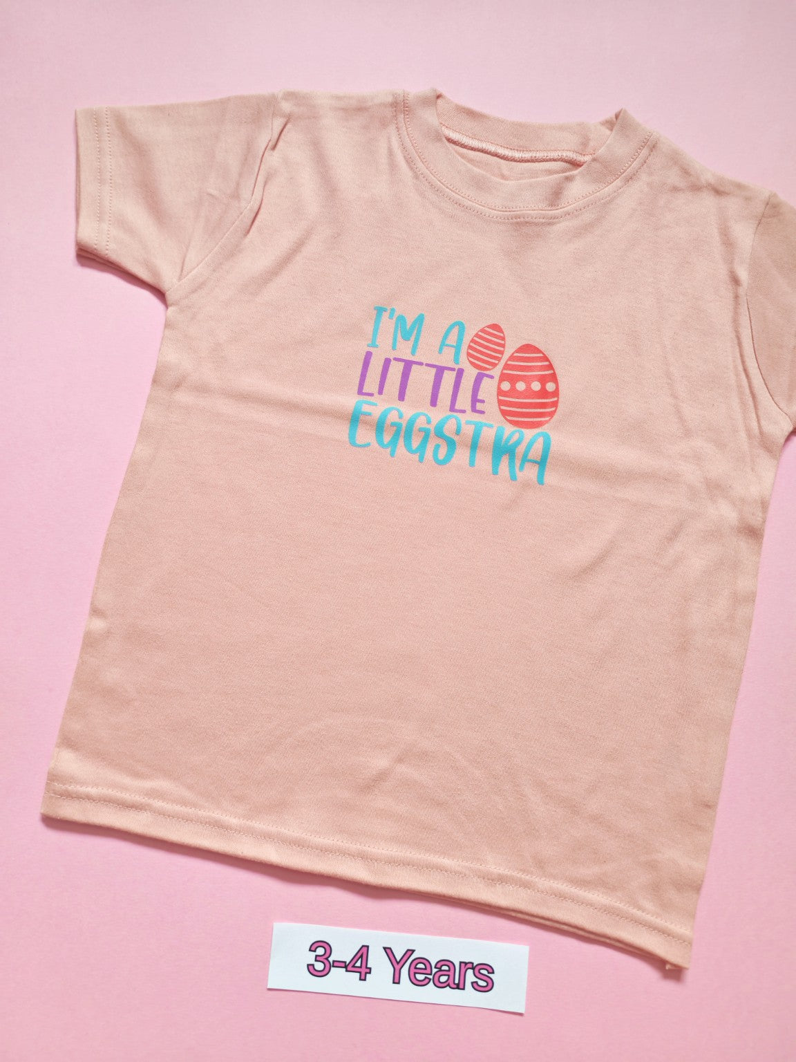 Pastel pink children's Easter T-shirt with I'm a Little Eggstra design, size 3-4 years
