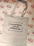 White cotton tote bag with Manifest Your Dreams quote