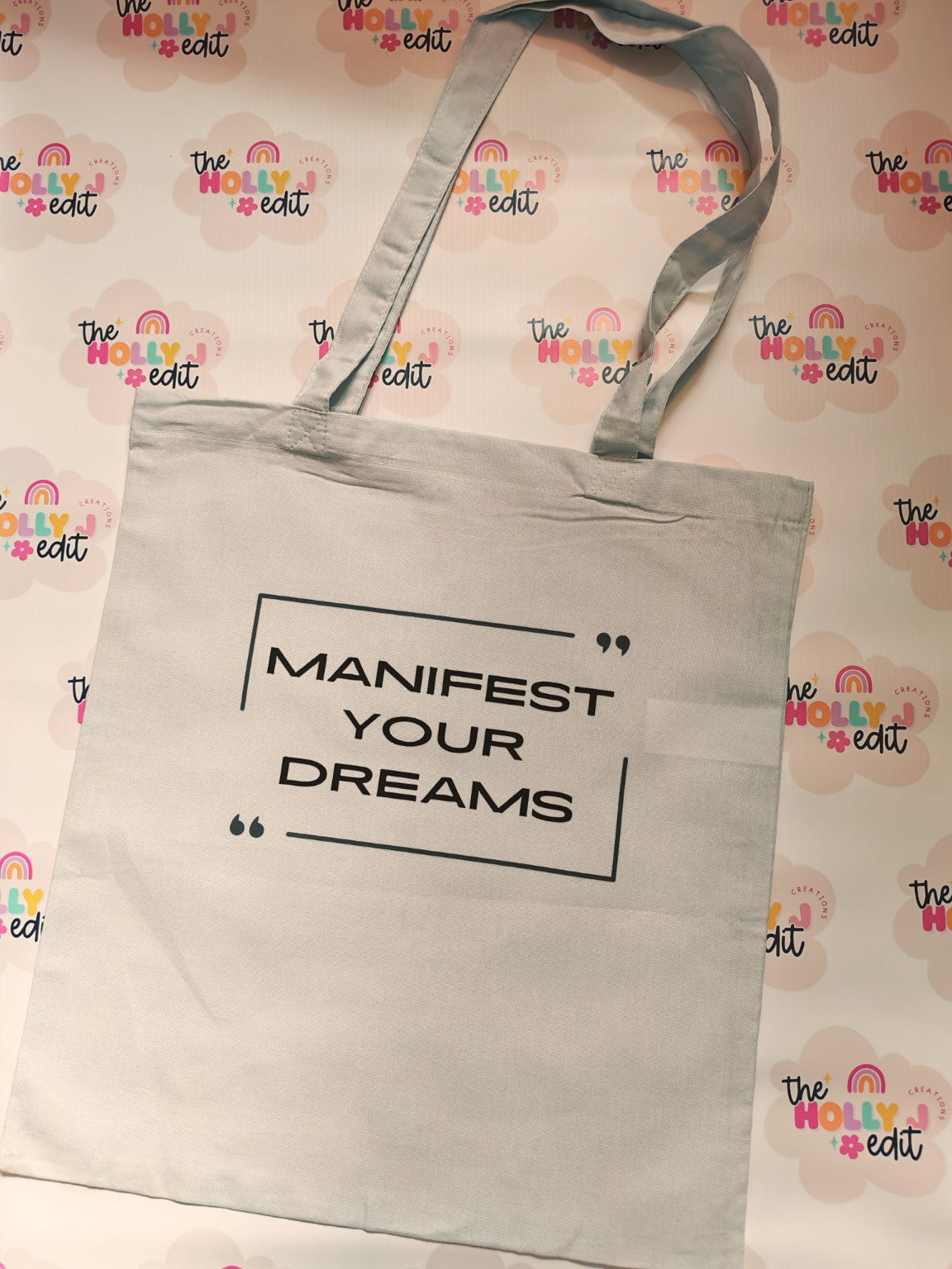 White cotton tote bag with Manifest Your Dreams quote