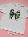 White children's T-shirt with black and white striped bow dripping with green slime, size 8 years