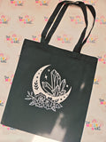 Black cotton tote bag with white crescent moon, crystals and floral design