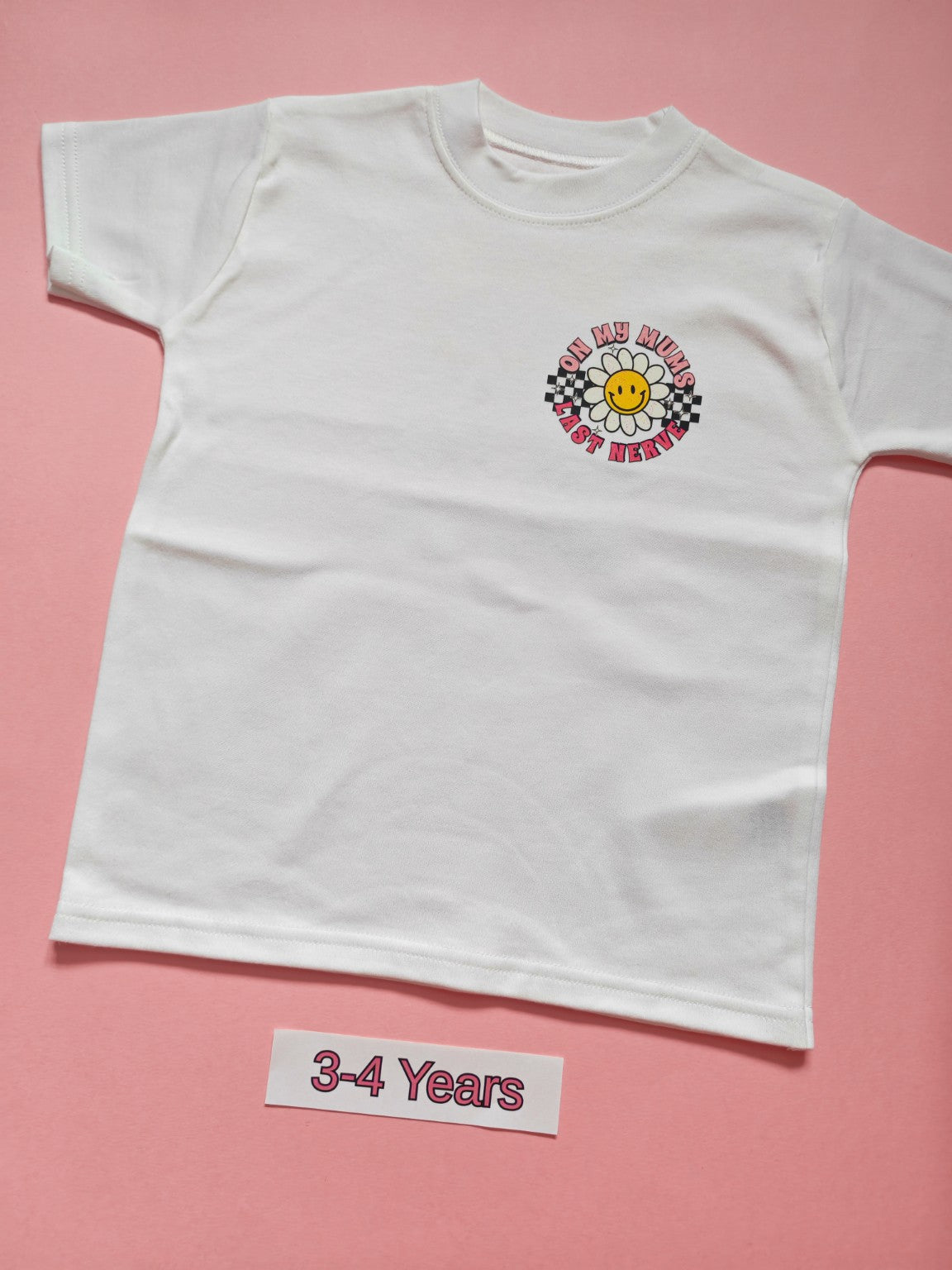 White children's T-shirt with pink daisy and checkerboard On My Mum's Last Nerve design, size 3-4 years