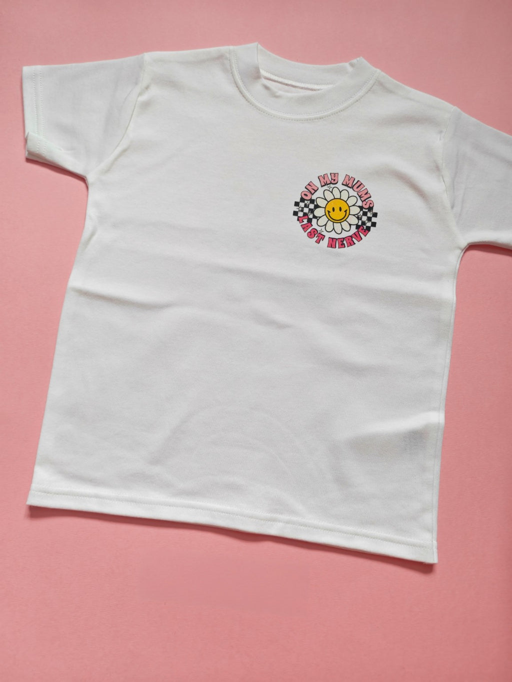 White children's t-shirt with pink On My Mum's Last Nerve daisy and checkerboard design, 4-5 years, front