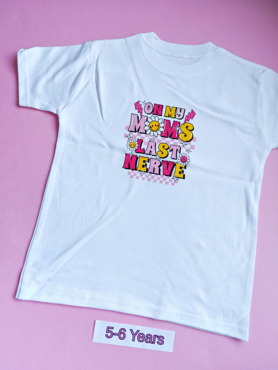 White children's t-shirt with colourful On My Mum's Last Nerve design on the back, 5-6 years