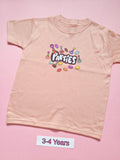 Pastel pink children's T-shirt with colourful Parties party hat design, size 3-4 years