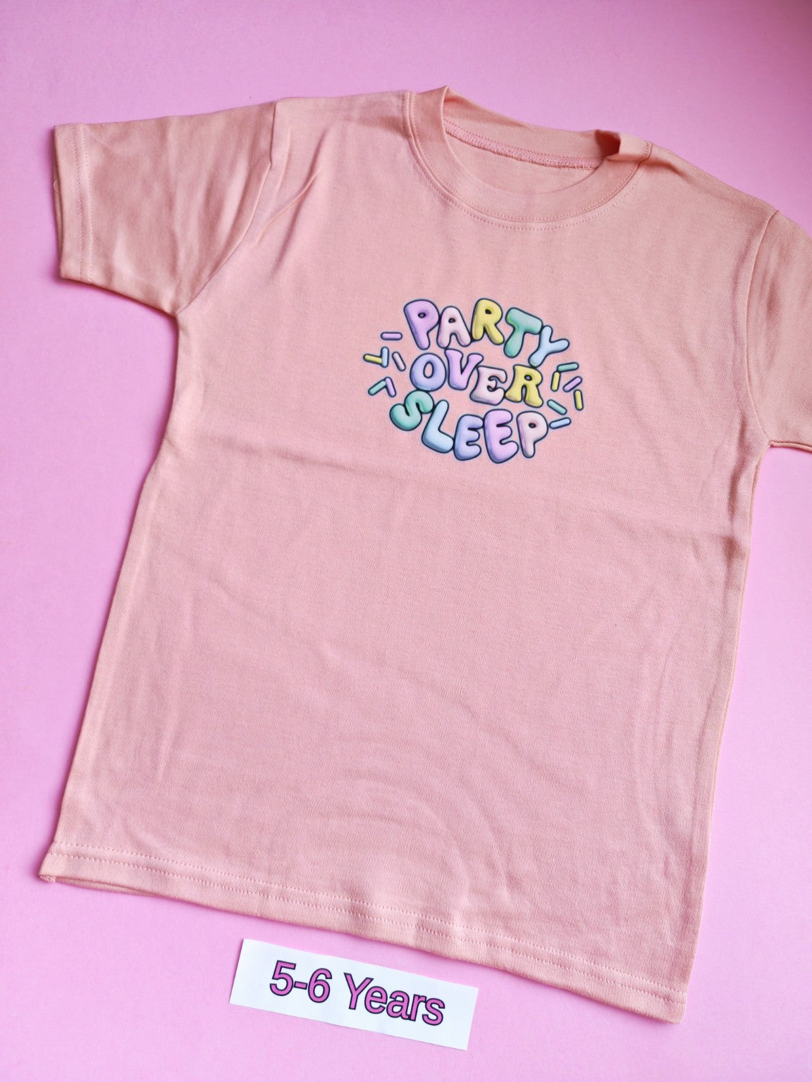 Peach children's t-shirt with colourful Party Over Sleep design, 5-6 years