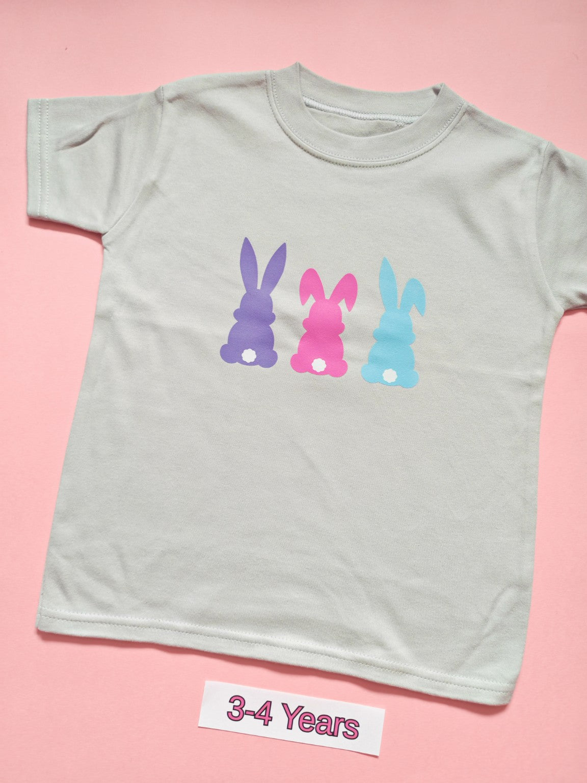 White children's T-shirt with three pastel bunny silhouettes, size 3-4 years