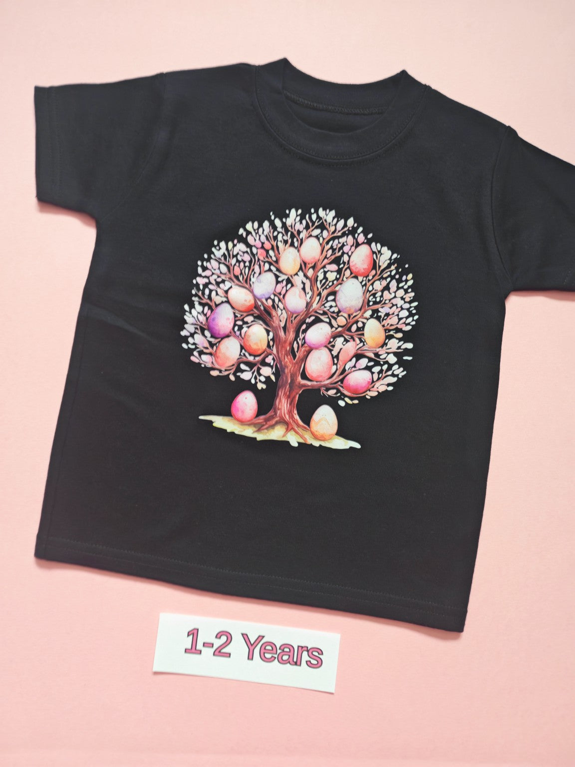 Black children's T-shirt with colourful pastel egg tree design, size 1-2 years