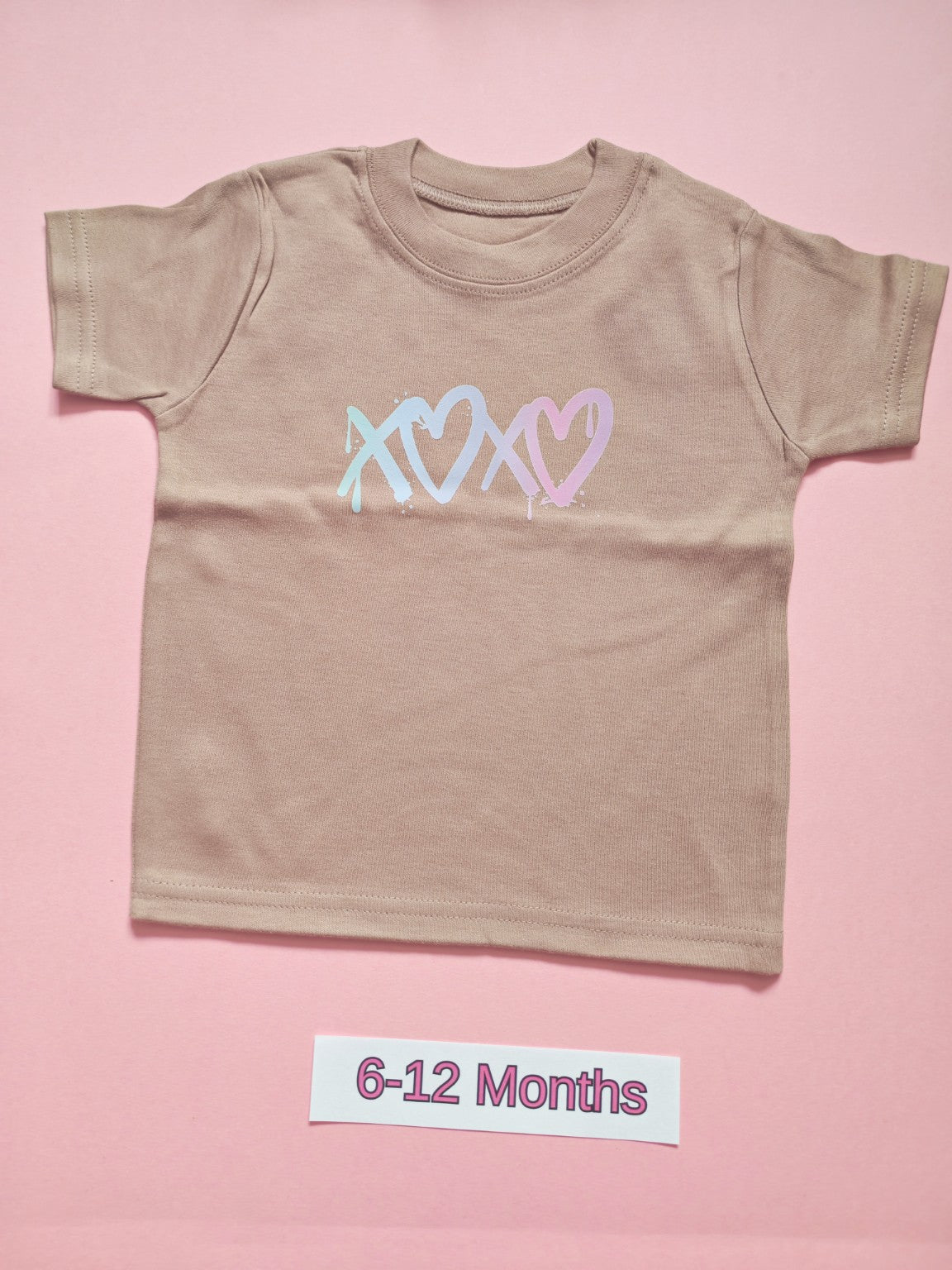 Taupe children's T-shirt with pastel blue and pink heart design, size 6-12 months