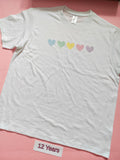 White children's T-shirt with pastel rainbow hearts design, size 12 years