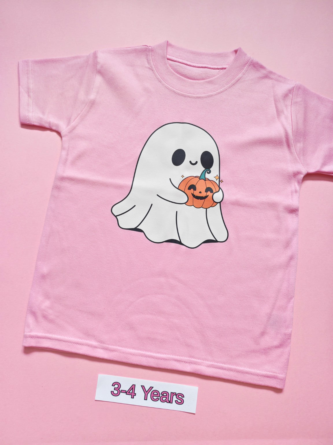 Pink children's T-shirt with cute ghost holding a pumpkin Halloween design, size 3-4 years