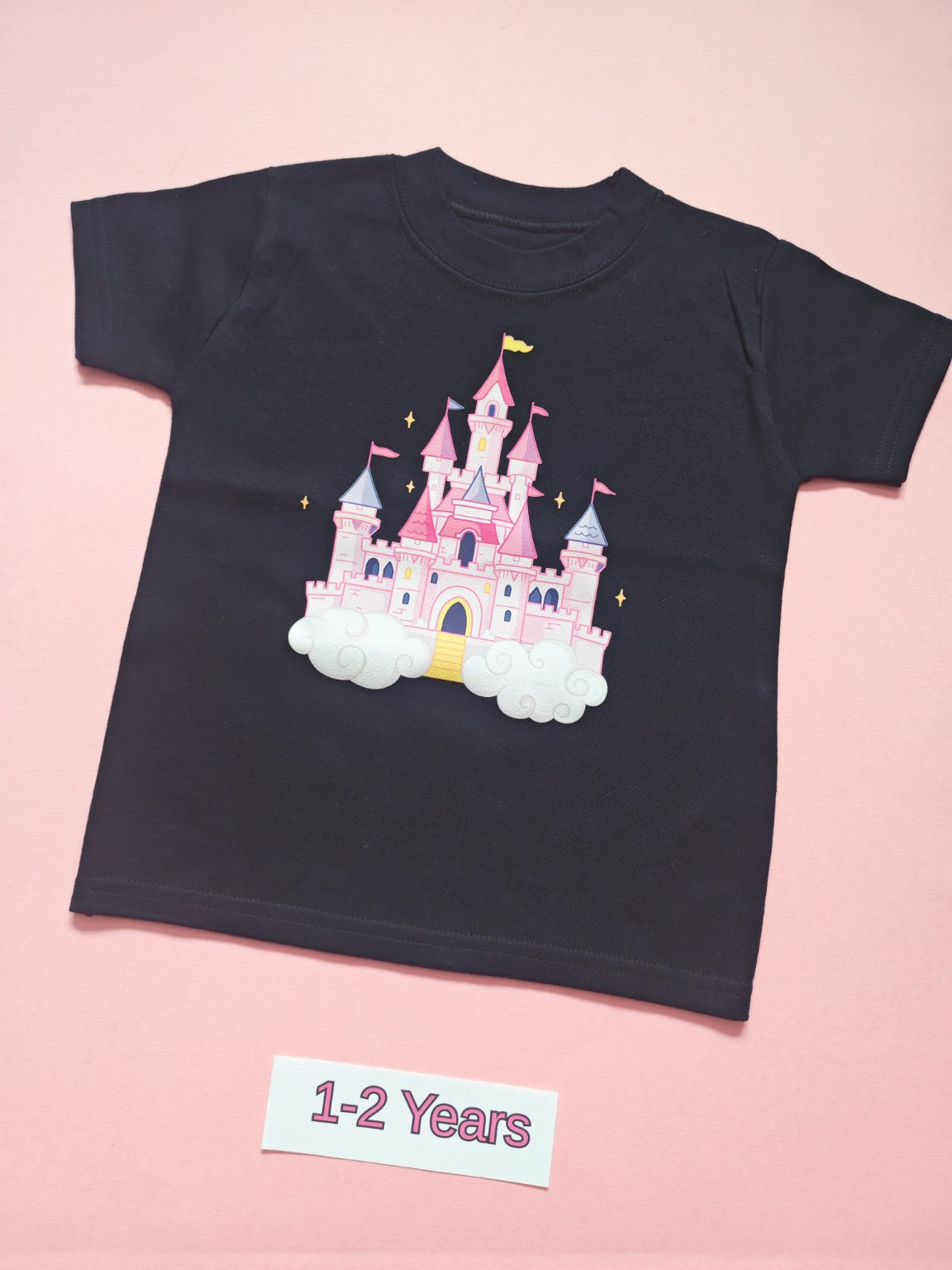 Black children's T-shirt with pink and pastel princess castle design, size 1-2 years