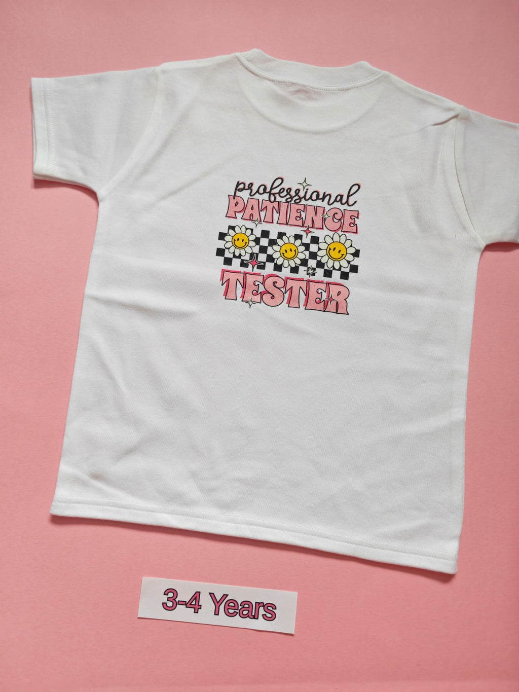White children's T-shirt back with pink daisy Professional Patience Tester design, size 3-4 years