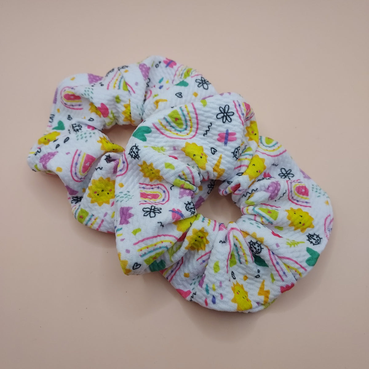White handmade scrunchie with colourful rainbow sunshine and hearts print