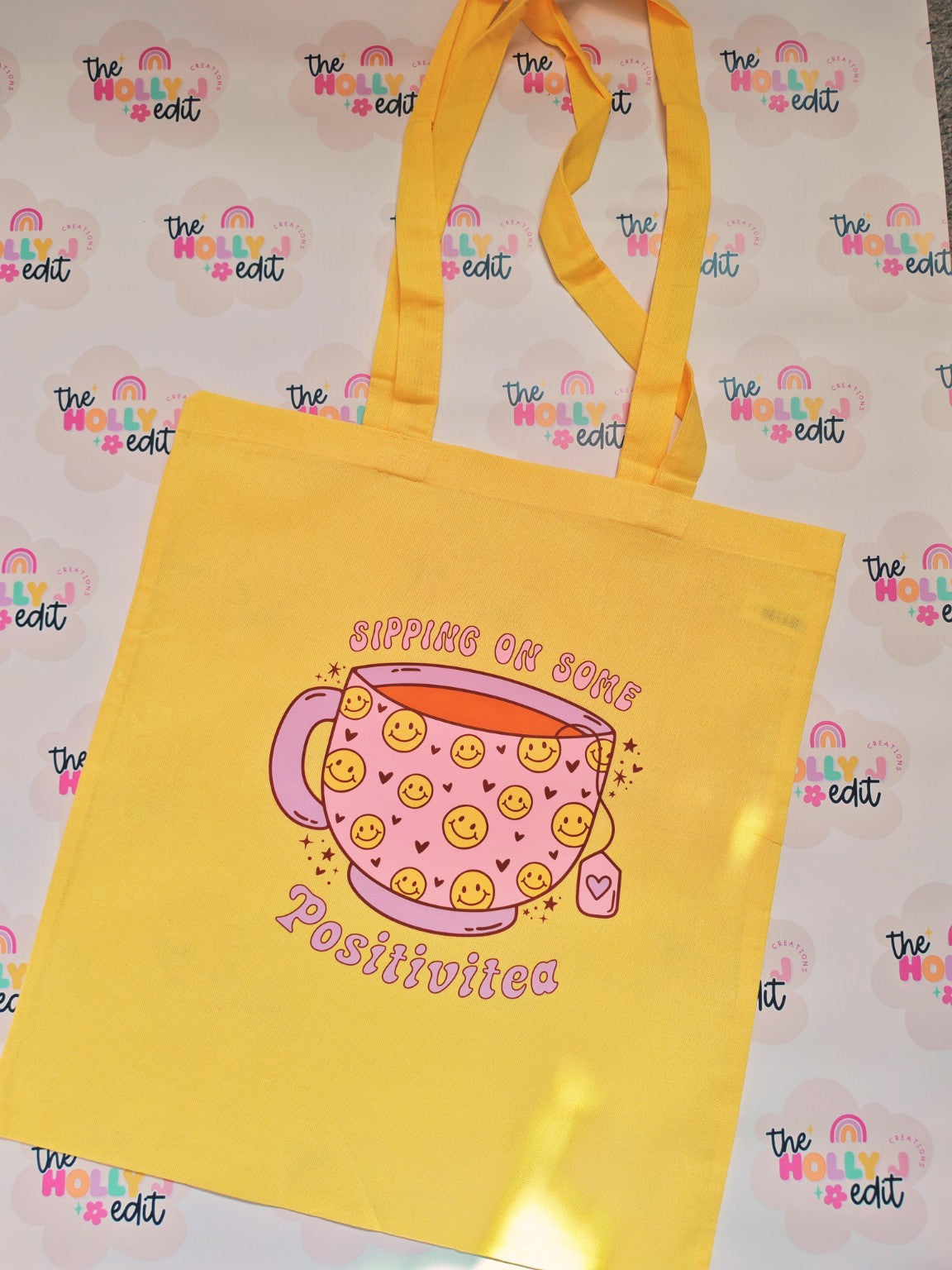 Yellow cotton tote bag with smiling teacup and Sipping on Some Positivitea design