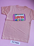 Peach children's t-shirt with colourful So Loved sweets design, 5-6 years