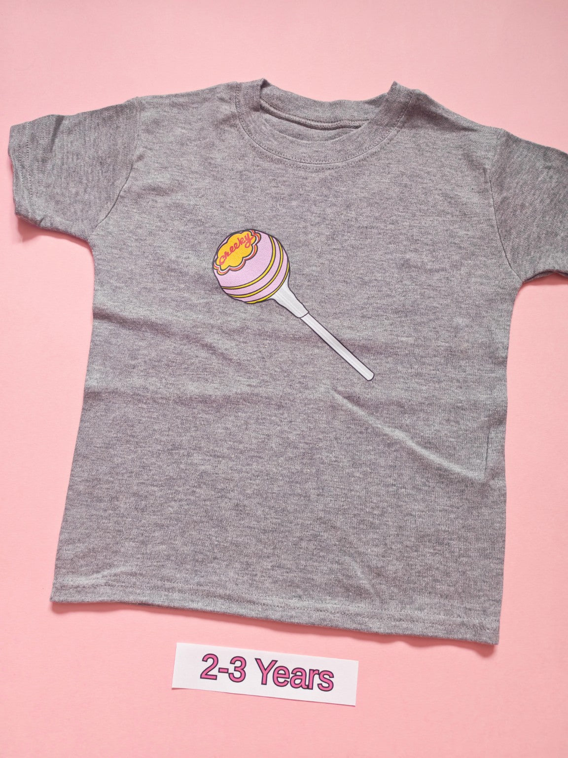 Grey children's T-shirt with pink and yellow lollipop design, size 2-3 years