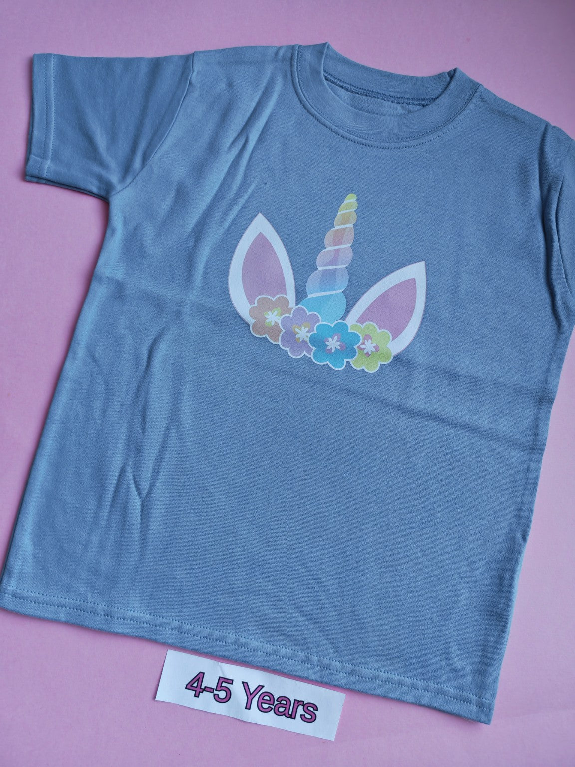 Blue children's t-shirt with pastel unicorn design, size 4-5 years