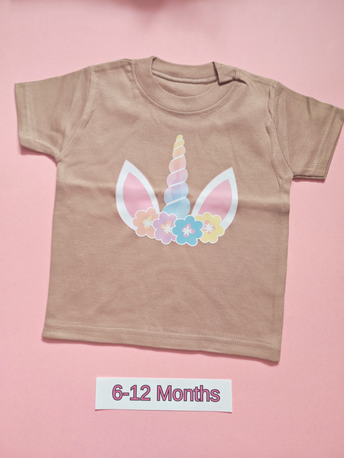Taupe children's T-shirt with pastel unicorn and floral design, size 6-12 months